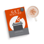 Photo of the book "Get elected" next to a cup of coffee