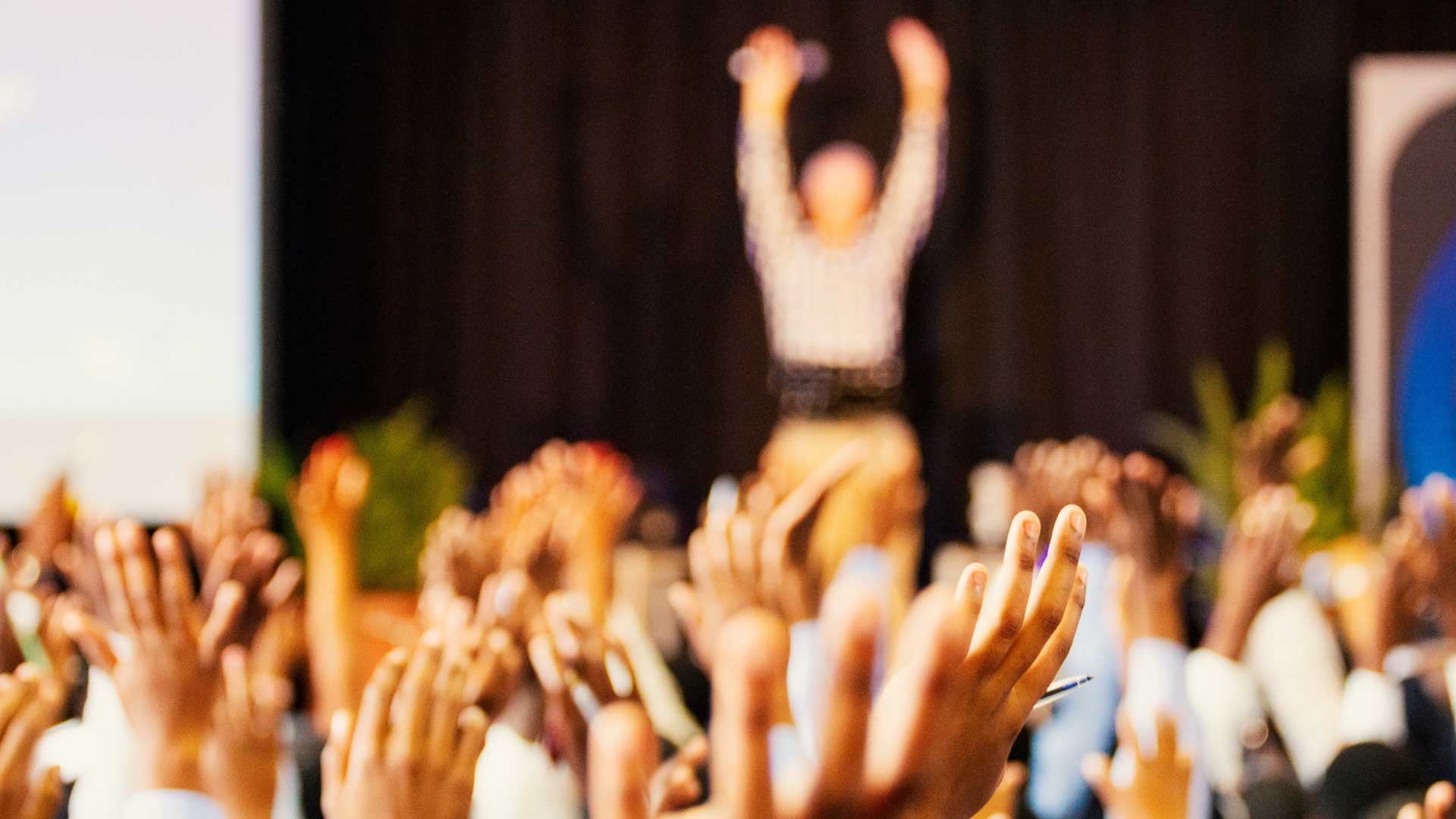 Photo of a room full of hands in the air
