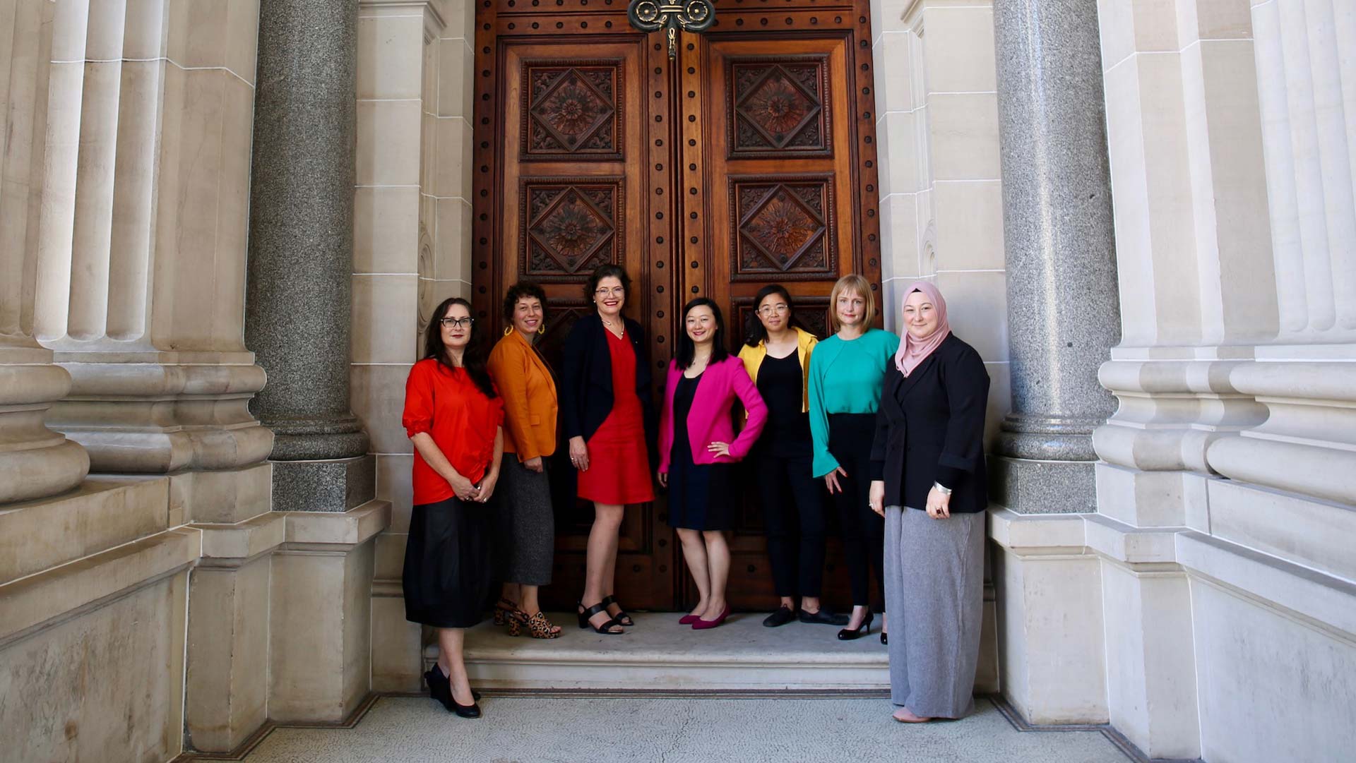 Group of diverse professional women standing outside Victorian Parliament