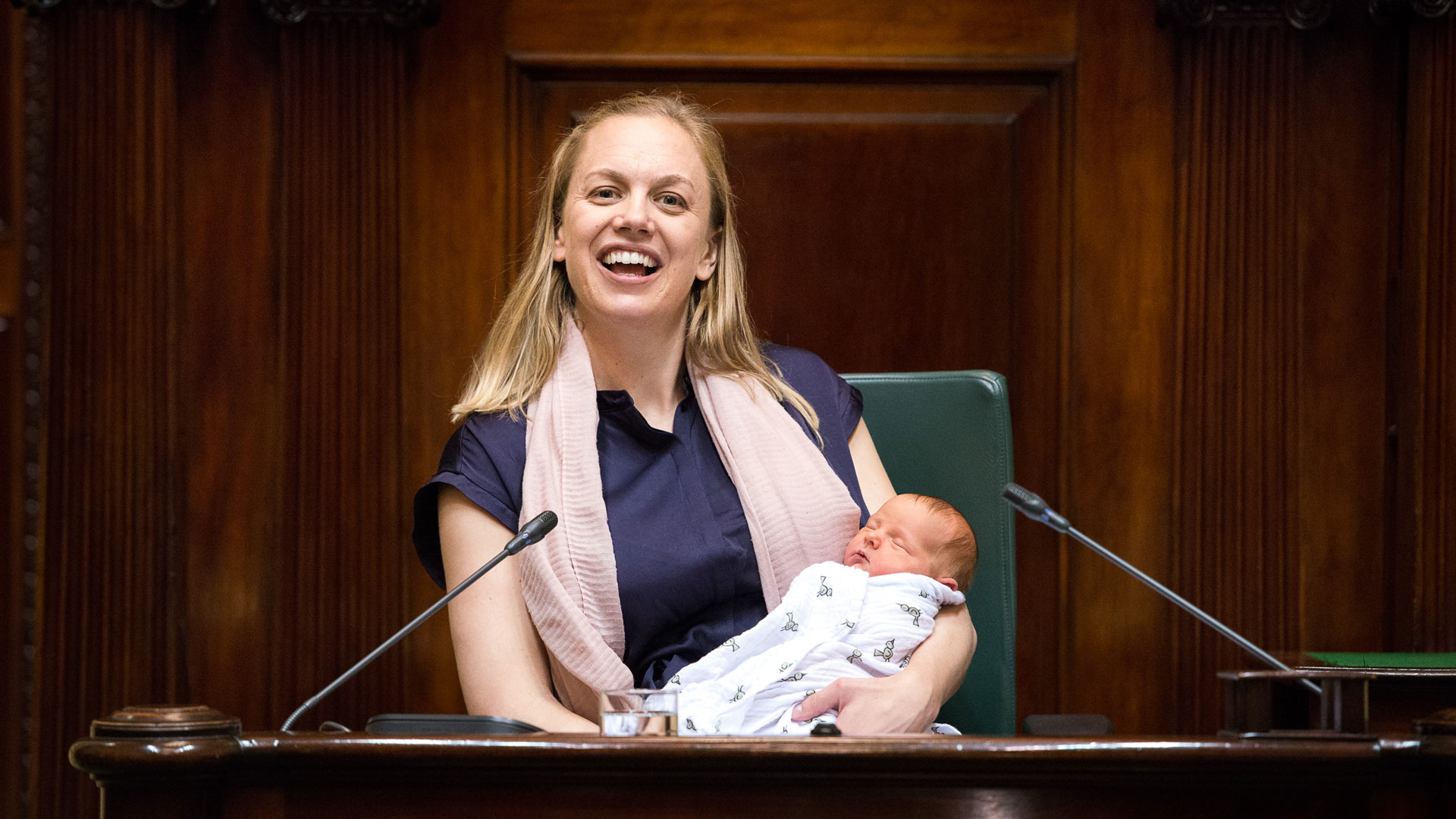 Photo of a woman holding a baby in parliament