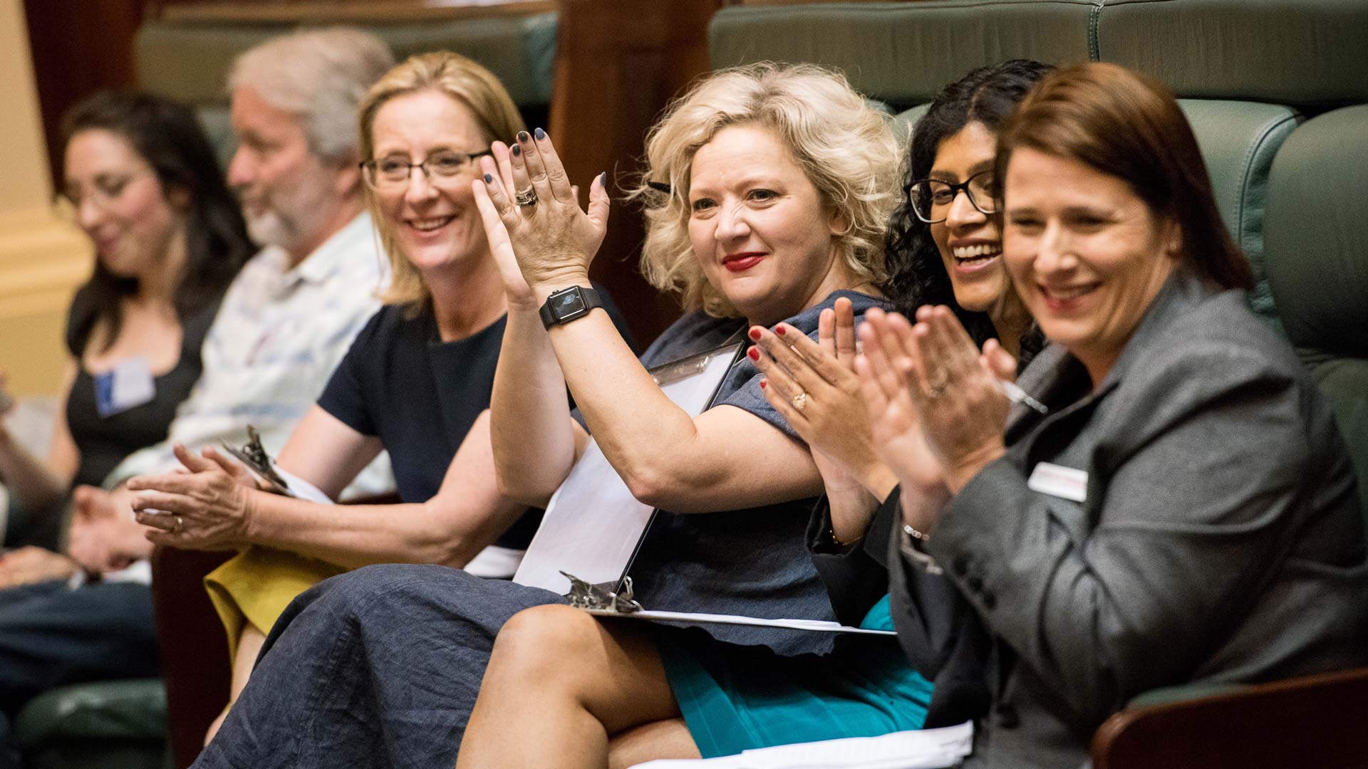 Photo of women sitting in parliament clapping