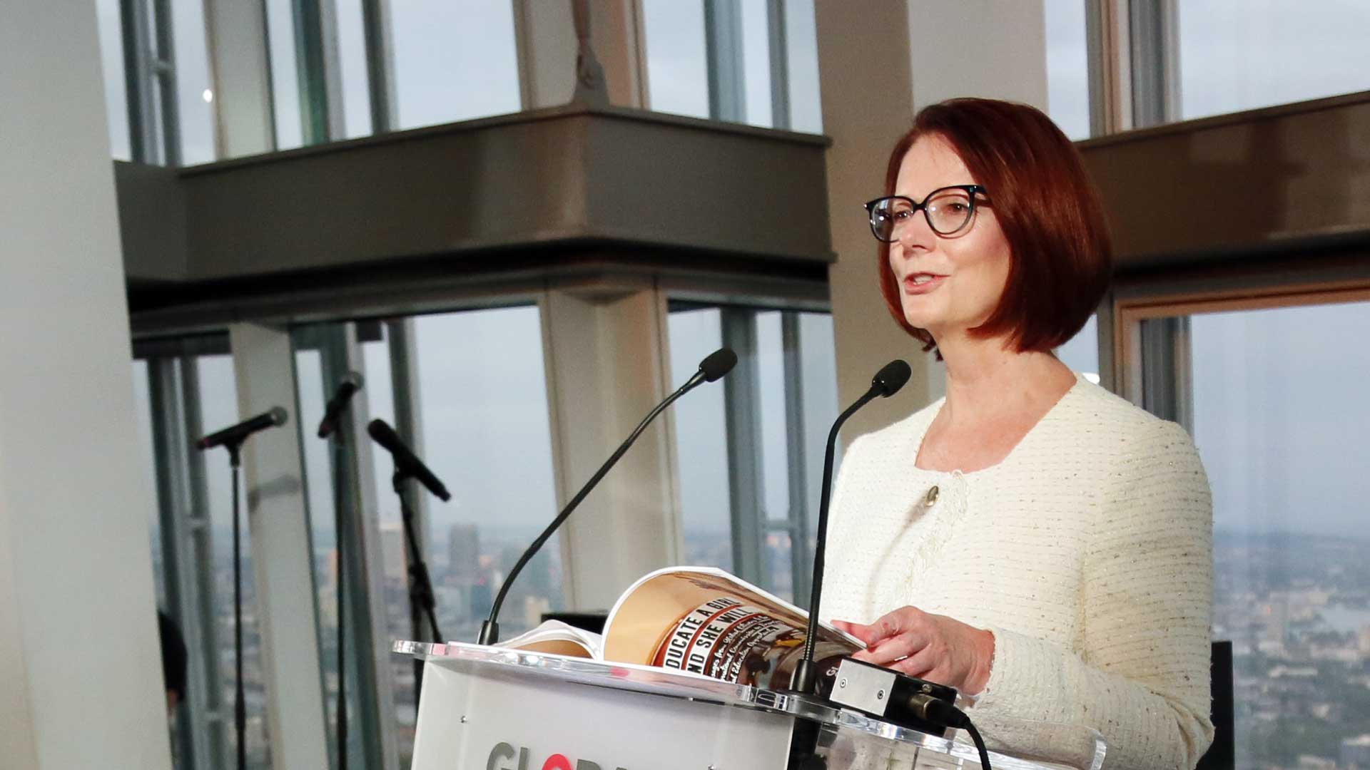 Julia Gillard standing at a podium giving a speech