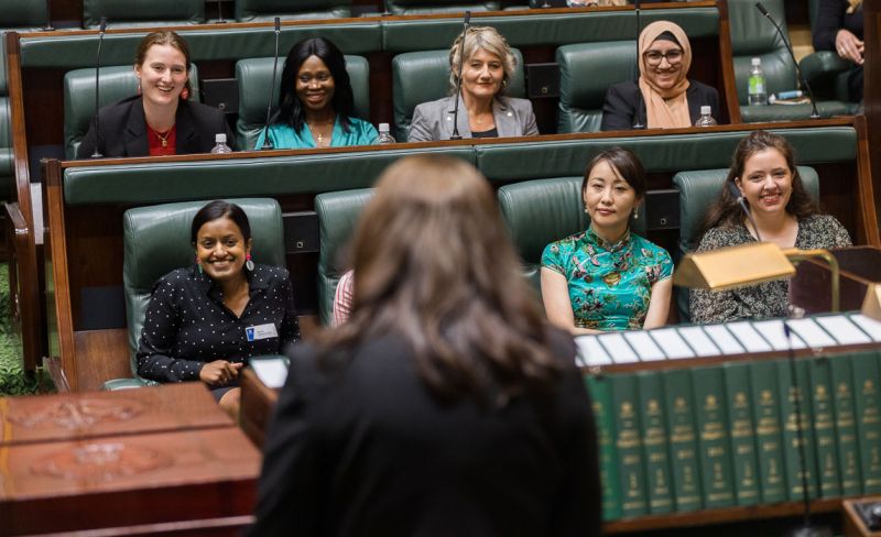 Pathways to Politics 2022 cohort: Group of diverse women sitting in Victorian Parliament House