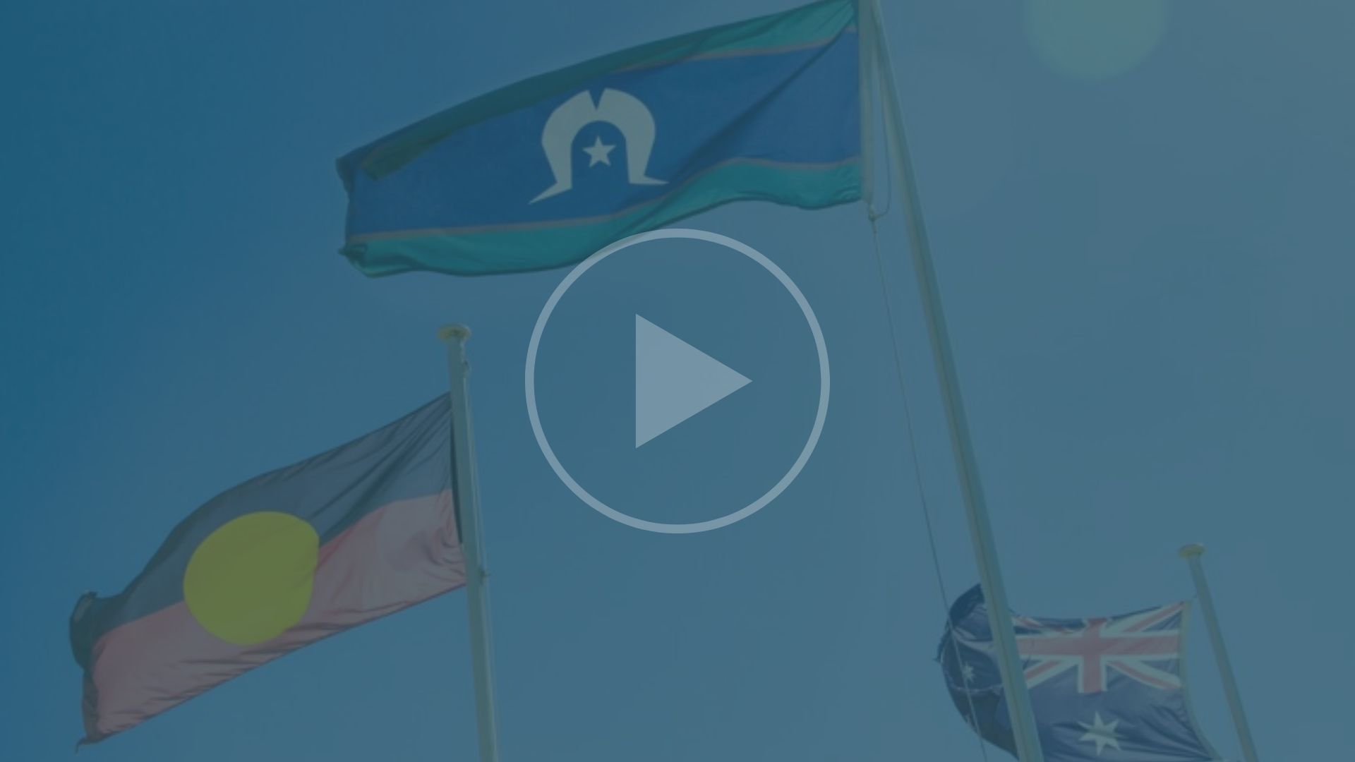 Photo of Aboriginal and Torres Strait Island flags with a 'play' symbol overlaid