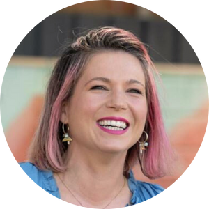 Smiling photo of a white woman with pink hair