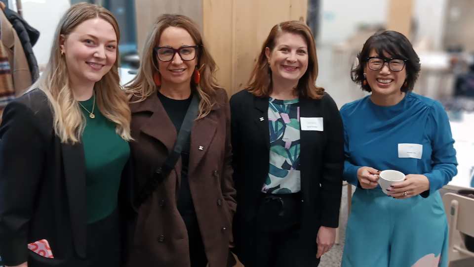 Group of four diverse women smiling