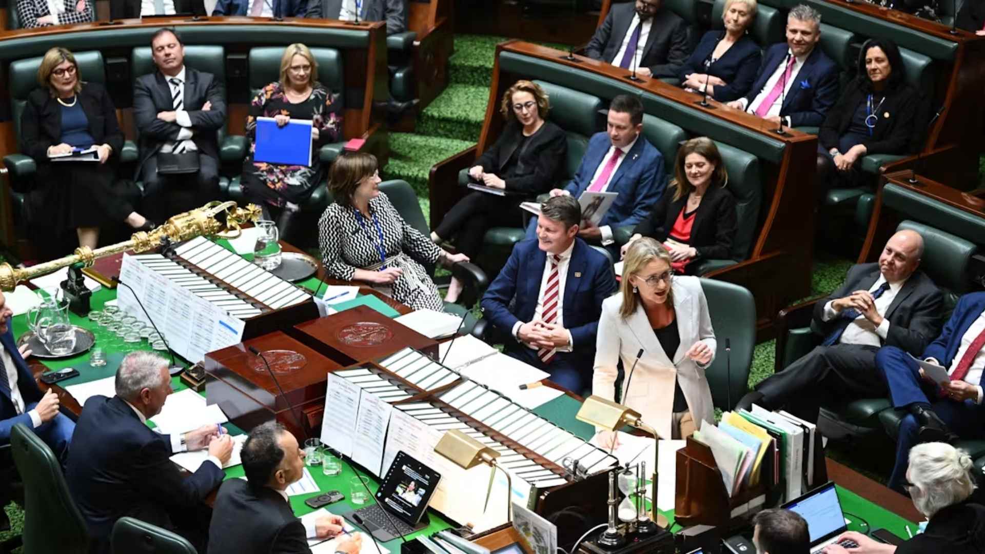 Photograph of the Victorian Parliament in session. Premier Jacinta Allen is standing and speaking at the centre dispatch box.