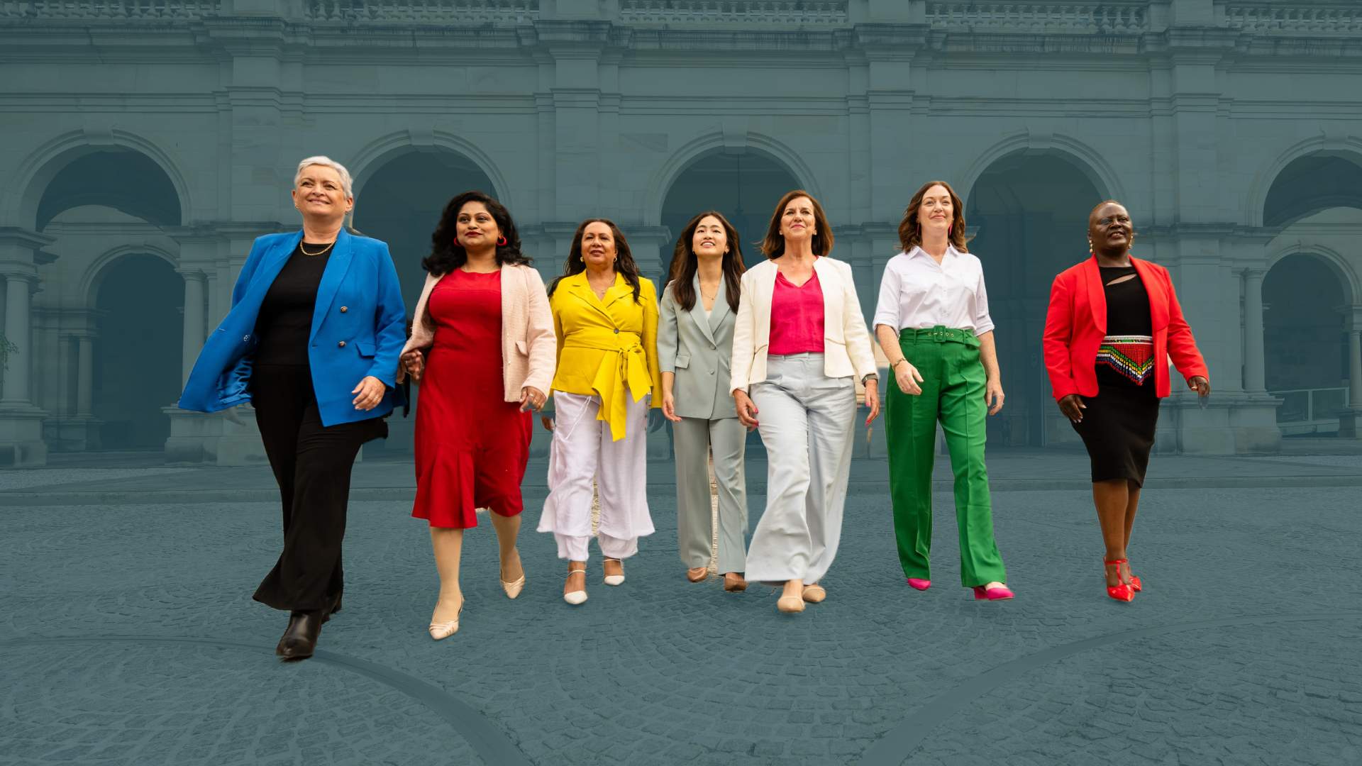 Stylised photo of 7 diverse women in bright block colours striding powerfully towards us, parliament in the background