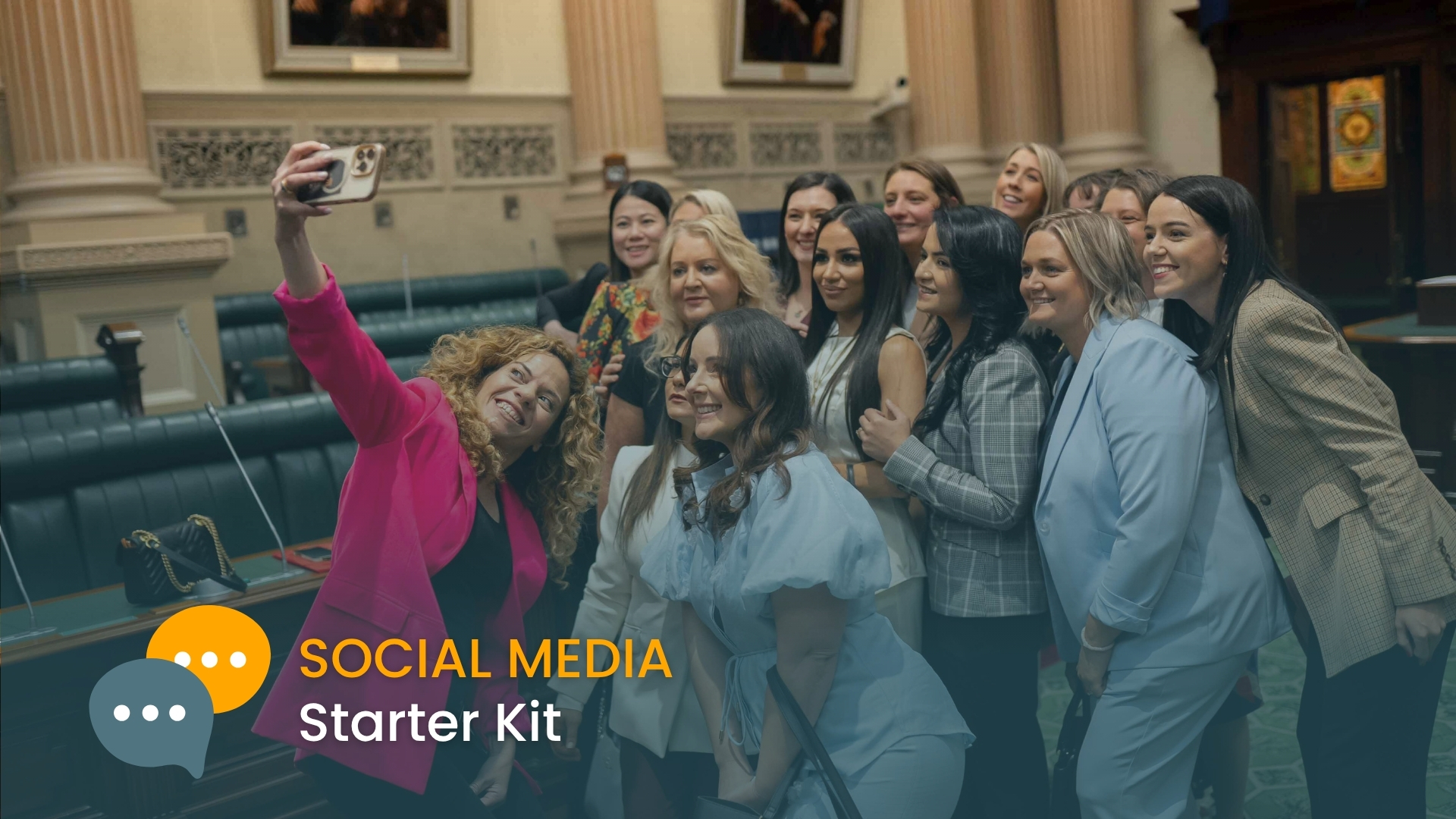 Group of smiling diverse women taking a selfie in parliament chamber