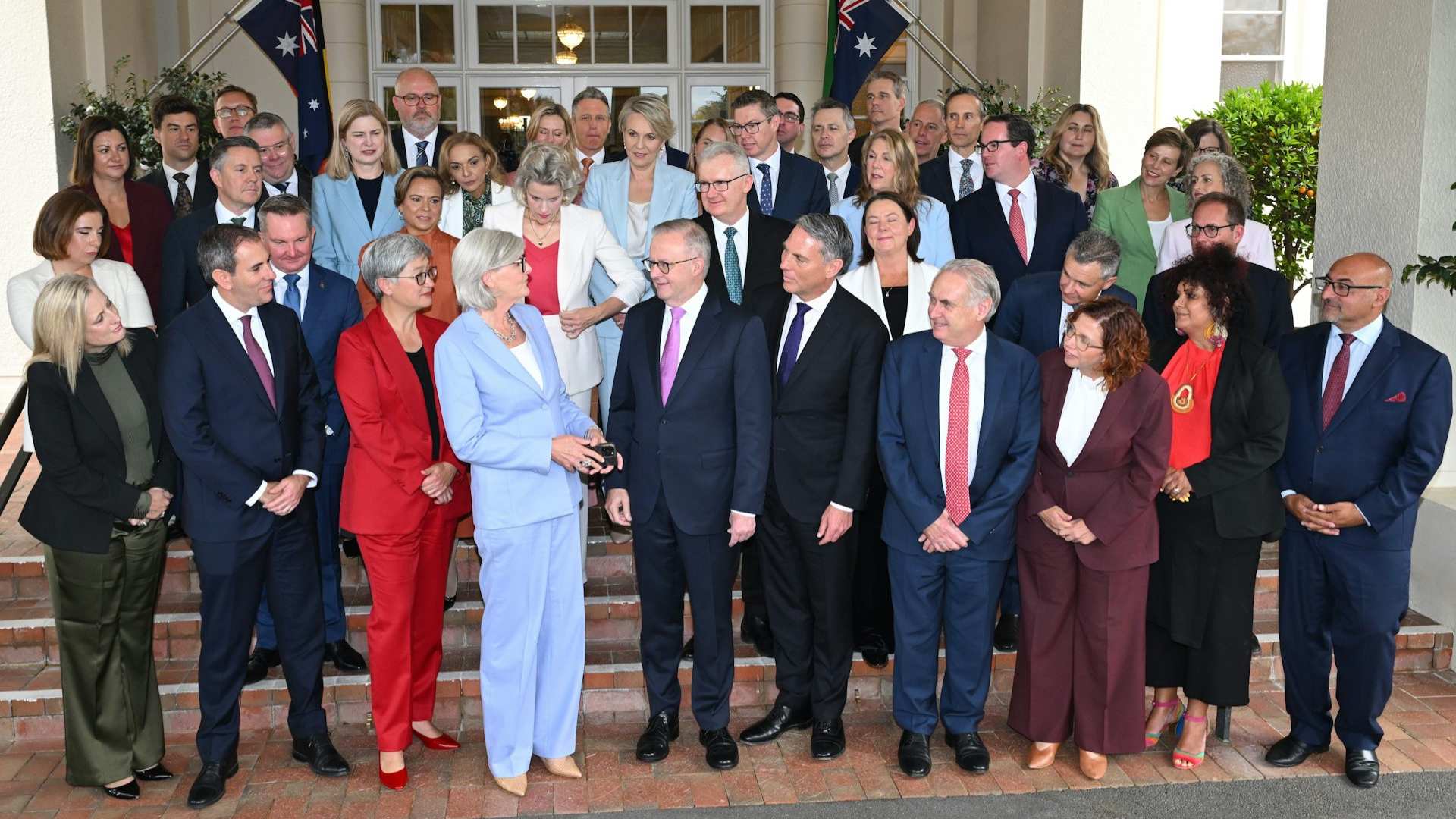 Labor MPs with the Prime Minister standing awkwardly before a group photo is abut to be taken