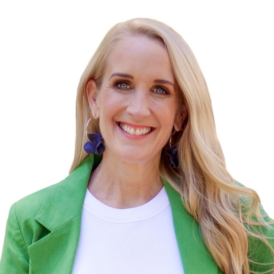 Photo of a woman with long blonde hair, smiling, wearing a bright green jacket and white blouse