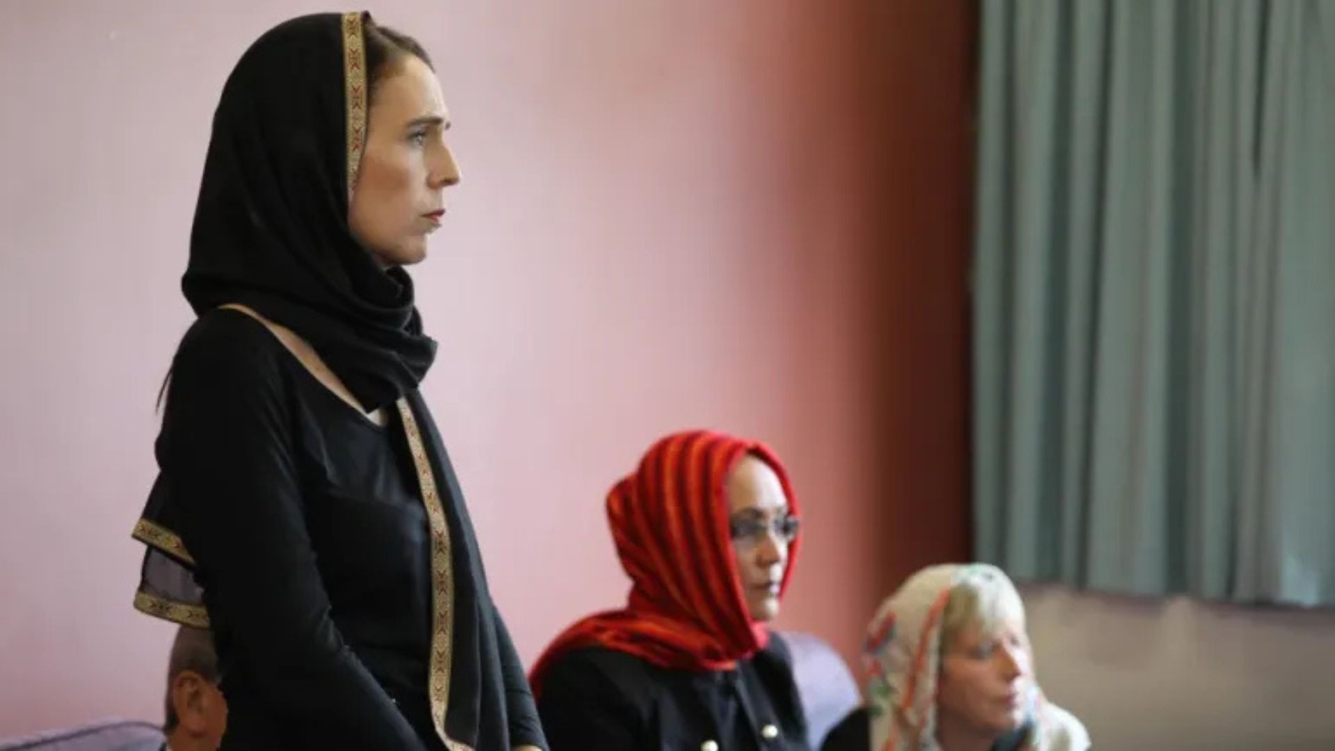 Photo of Jacinda Ardern wearing a black headscarf, a serious expression on her face