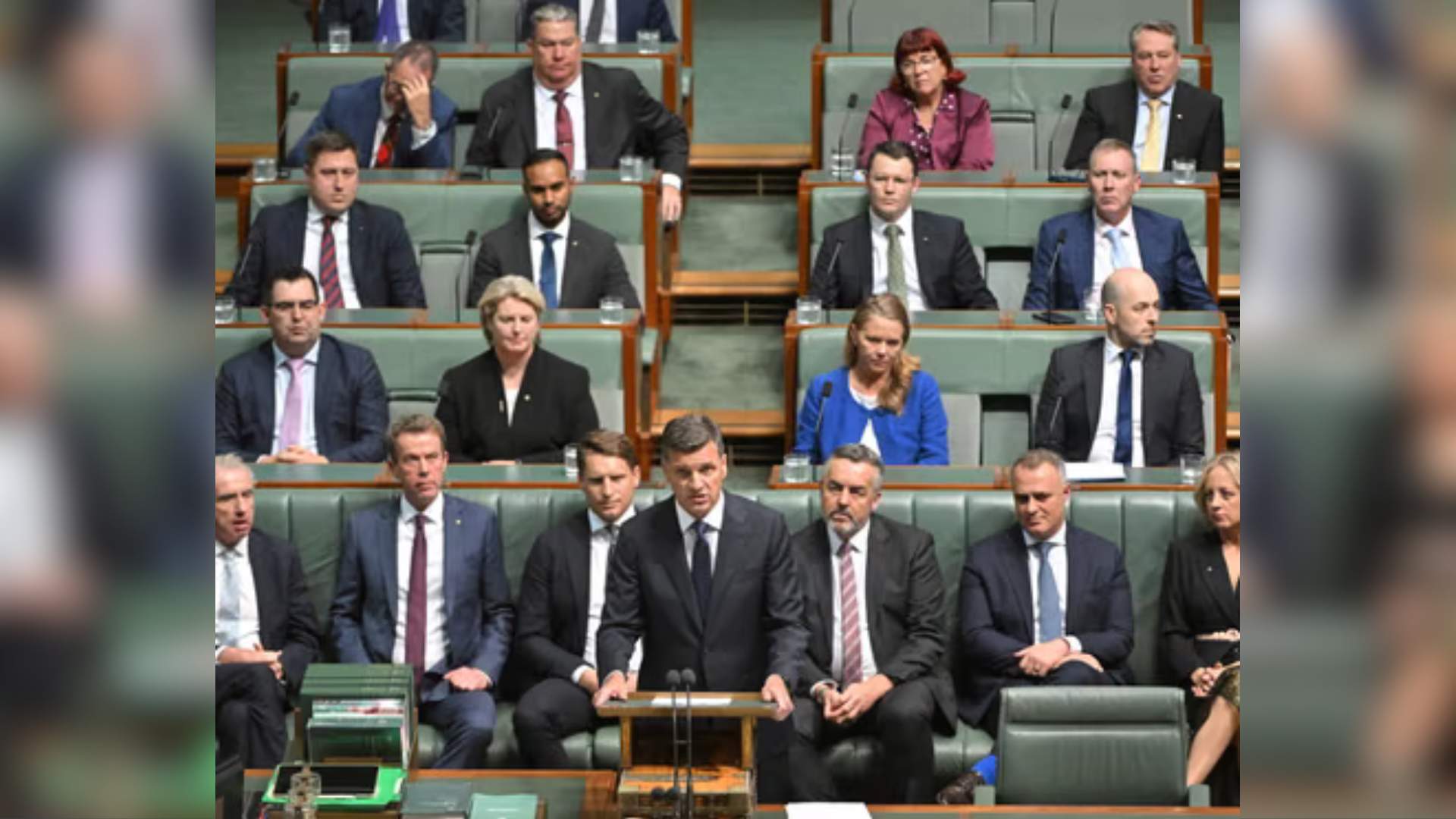 Liberal party members seated in the lower house. Leader Angus Taylor is standing at the dispatch box, many male members of the party and a couple of women listen behind him