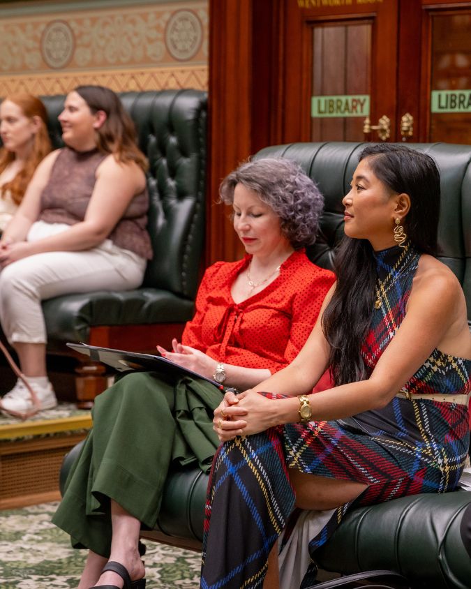diverse women sitting on green leather benches in the NSW parliament