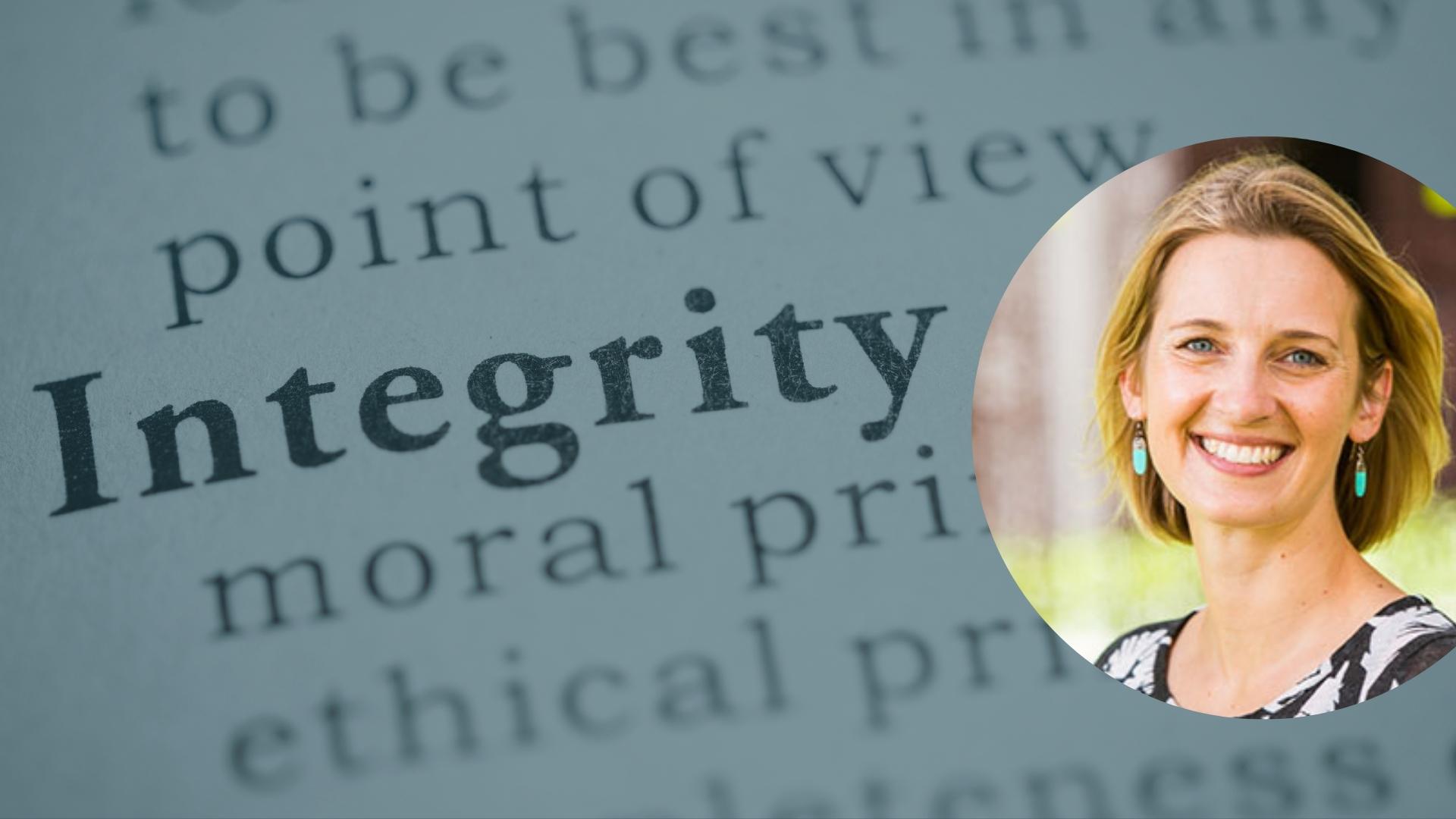 Close up of the word "integrity" in the dictionary, overlaid with a portrait photo of Gabrielle Appleby, a smiling white woman with blonde hair